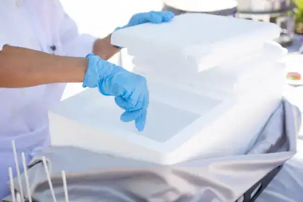 A medical worker uses dry ice to freeze a shipment
